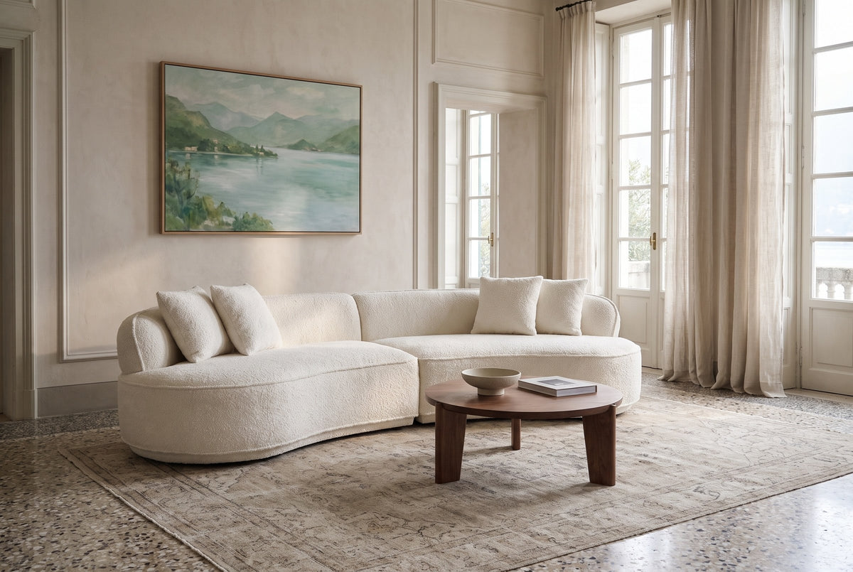 The Fiora sofa in White in a villa salon on Lake Orta, with terrazzo, a faded rug and a round walnut coffee table