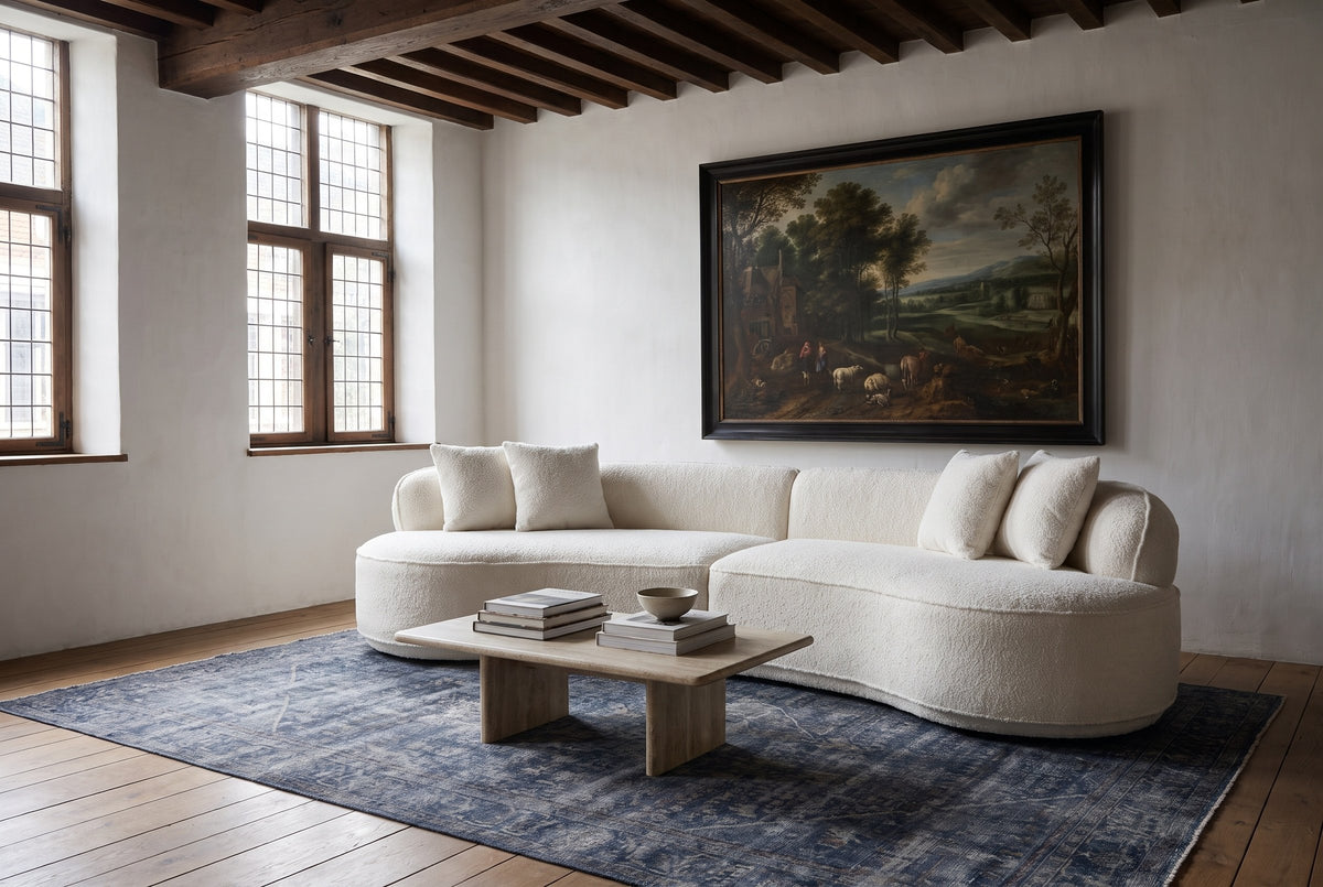 The Fiora sofa in White in a 17th-century Mechelen townhouse with dark oak beams and an indigo Oriental rug