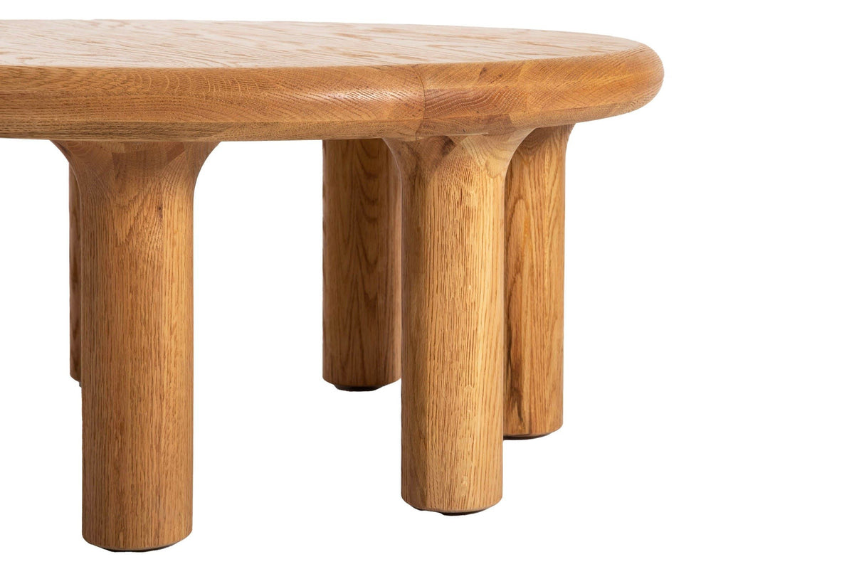 Close-up of the Fontanellato legs in Natural Oak: thick round pillars that flare with a soft curve into the top