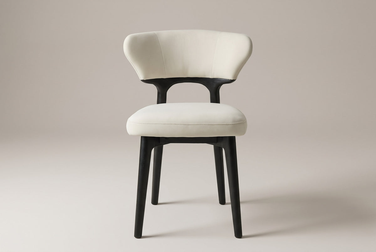 Fosdinovo dining chair, straight front view: wing-shaped cream backrest, open arch, thick cream seat, four black legs