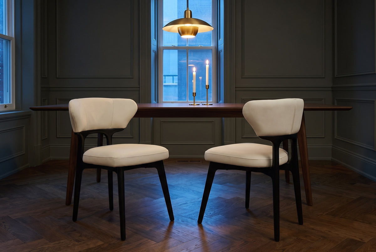 Two Fosdinovo dining chairs in front of a walnut table in a panelled Toronto dining room at dusk under a brass pendant lamp
