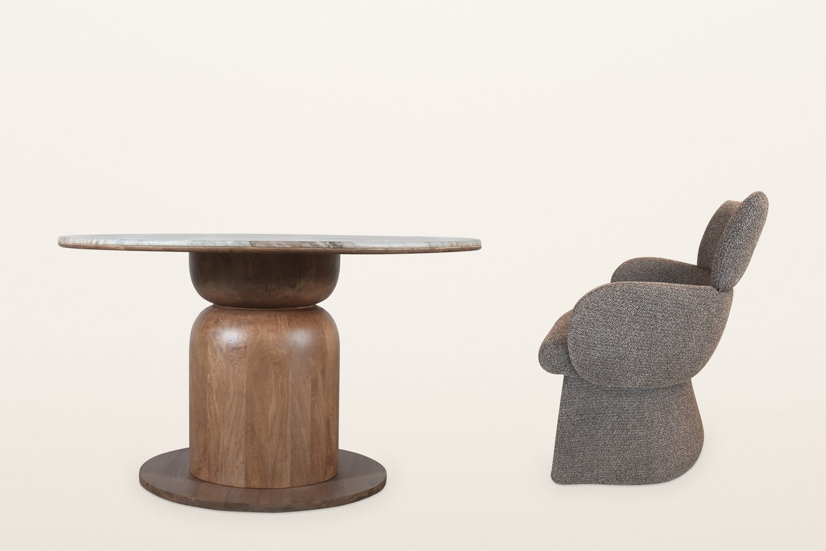Frascati table and one brown boucle chair, side view: the pedestal on its round plinth, the chair's tall back