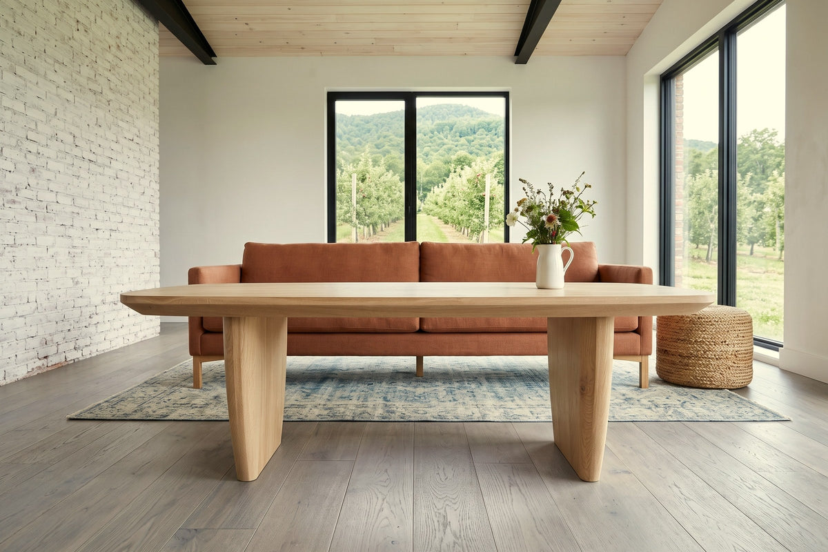 Frontino coffee table in Biscotti Oak seen low from the side before a terracotta linen sofa in a Frelighsburg orchard house