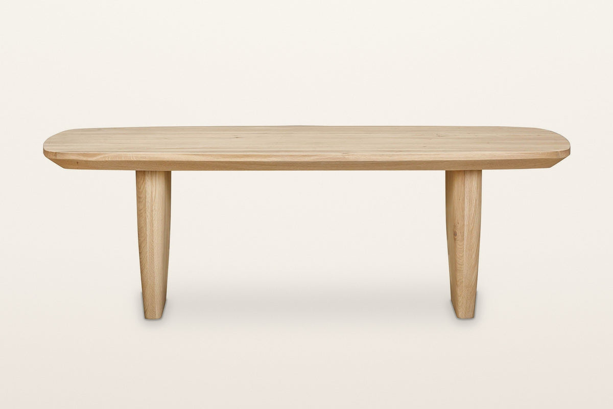 Frontino coffee table in Biscotti Oak, straight front view on a warm white studio backdrop: from the front each slab reads