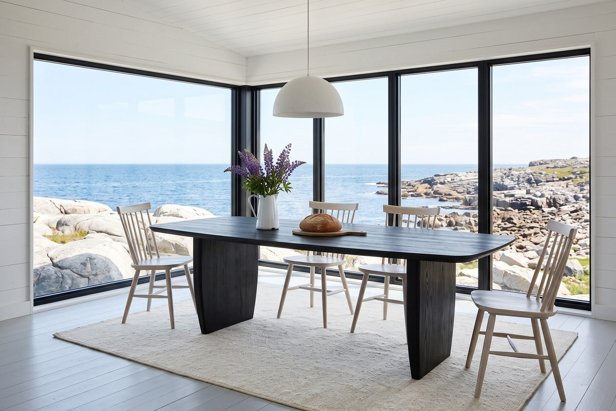 Frontino dining table in Black in a Fogo Island saltbox house, with white board walls