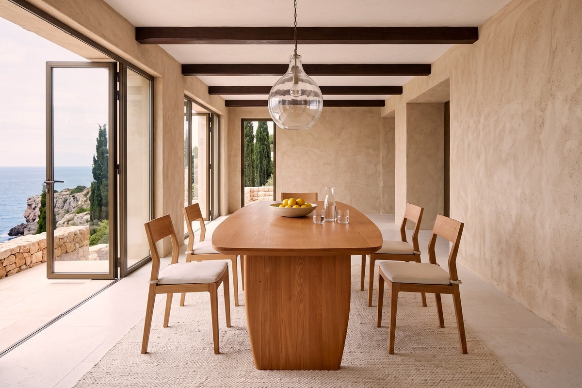 End view of the Frontino dining table in Honey Brown in a Cascais cliff-top villa, with lime-rendered walls
