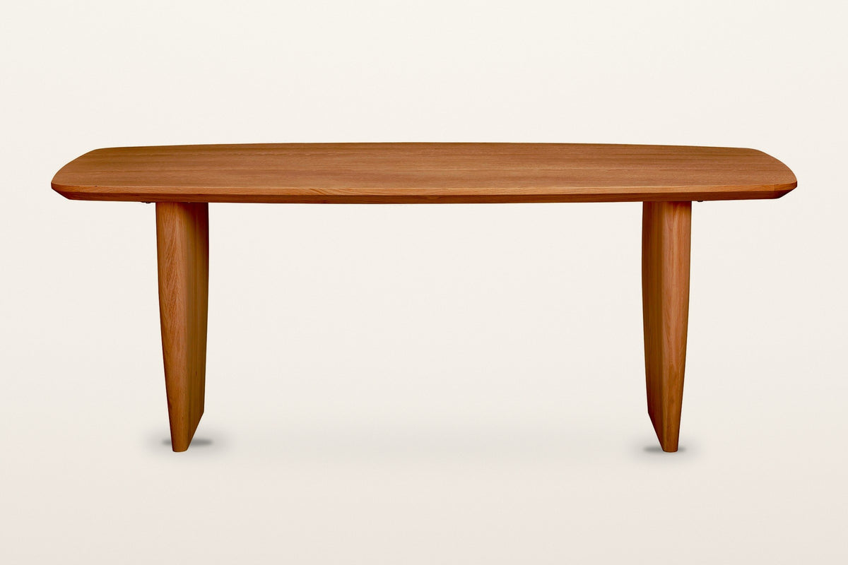 Frontino dining table in Honey Brown, straight front view on a warm white studio backdrop
