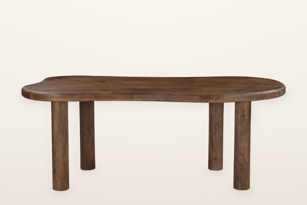 The Gaiole table alone, long side: the freeform solid mango top with its thick rounded edge on four round post legs