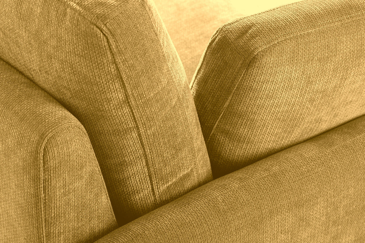 Close-up of the ribbed mustard yellow chenille where the arm, the back cushion and a pillow meet
