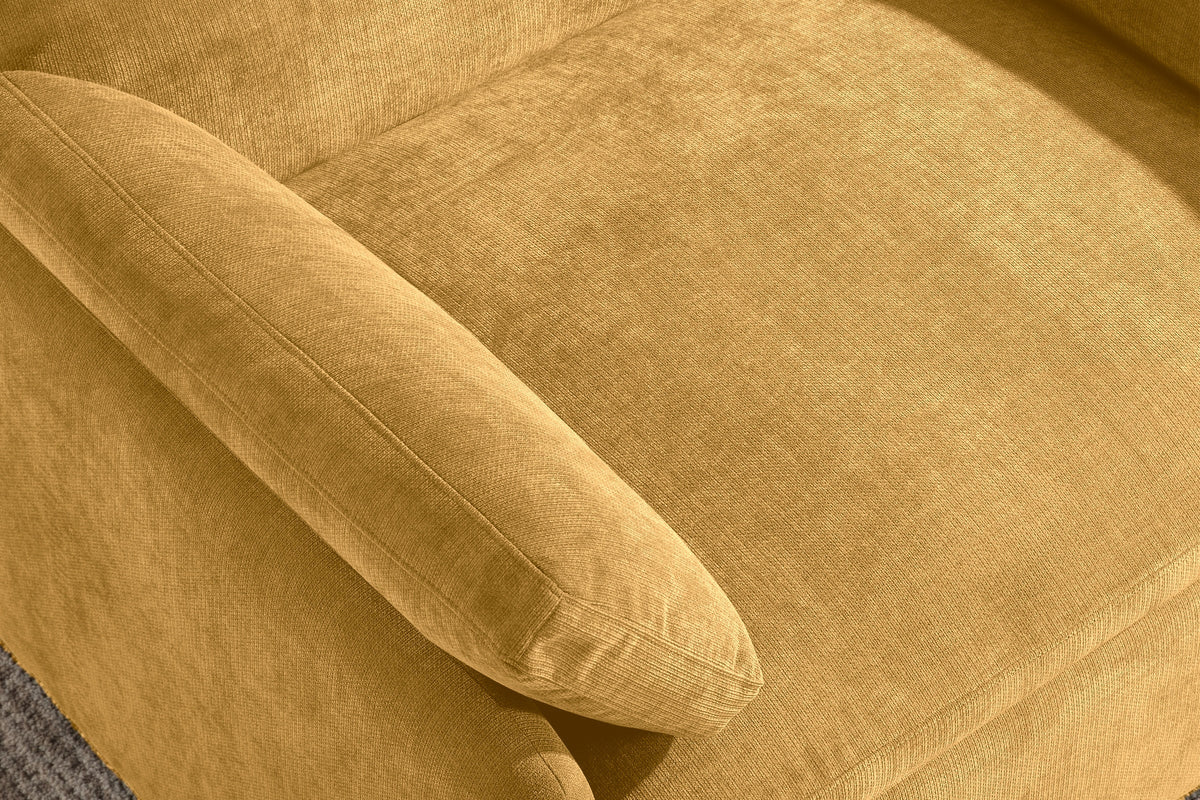 Close-up of the mustard yellow chenille seat cushion, a throw pillow and the rounded arm