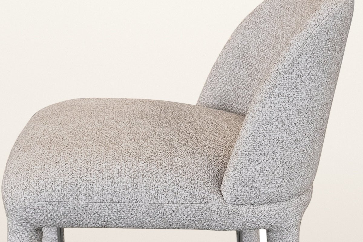 Close-up of the beige multi-tone textured fabric on the seat and the curved back of the Gavi counter stool