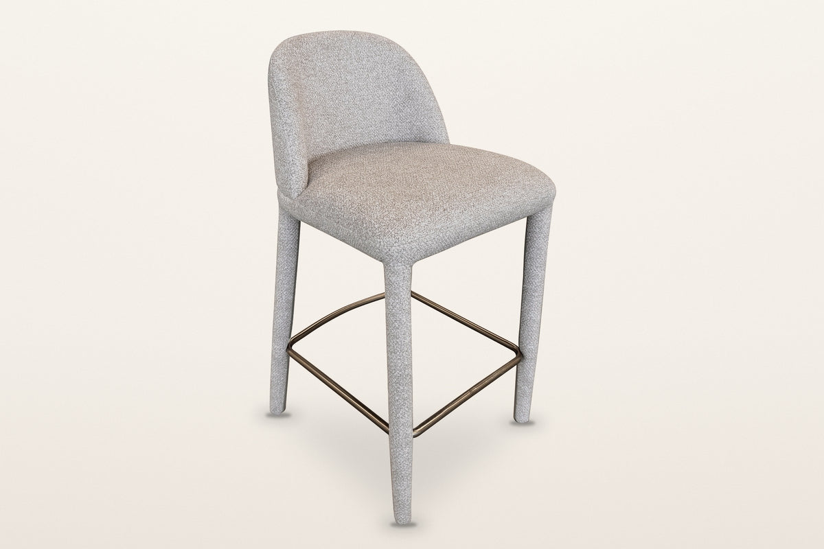 Gavi upholstered counter stool in beige, three-quarter view on a warm white studio backdrop