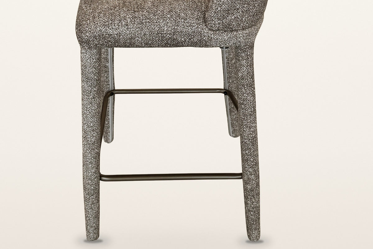 Gavi base in brown from the side: four fabric-wrapped legs and the aged-gold metal footrest