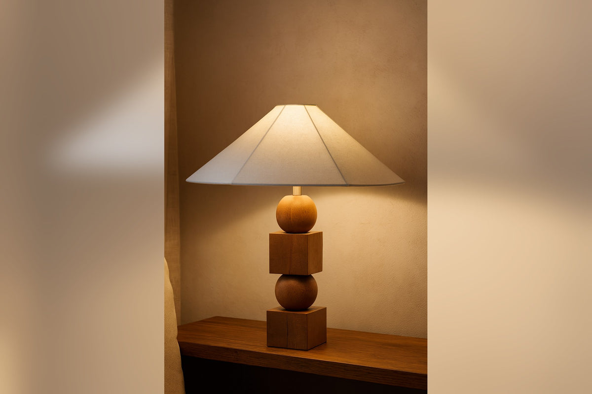 Geneva lamp glowing on a wood sideboard in a warm, softly lit room