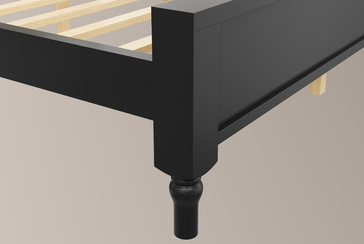 Close-up of the black Gradara footboard corner: flat cap, square post, framed panel and a turned foot