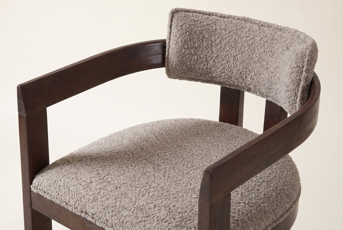 Close-up of the Gradisca floating back pad, the curved wooden rail and the piped seat: taupe boucle on the Espresso frame