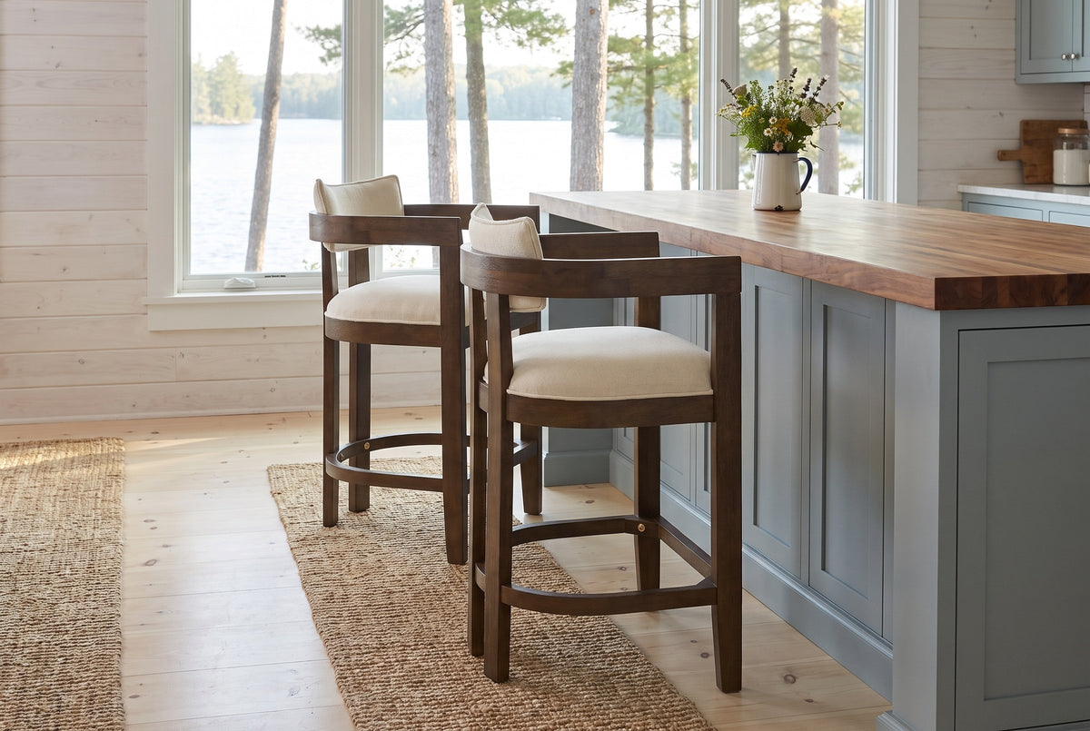 Two Gradisca counter stools at a butcher-block island in a Muskoka cottage kitchen with a window onto the lake