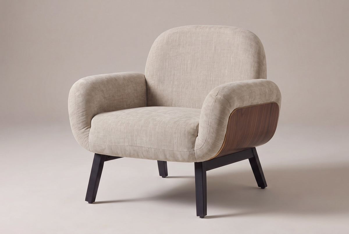 Grado shell-arm accent chair in oat chenille-look fabric, three-quarter view on a warm grey studio backdrop