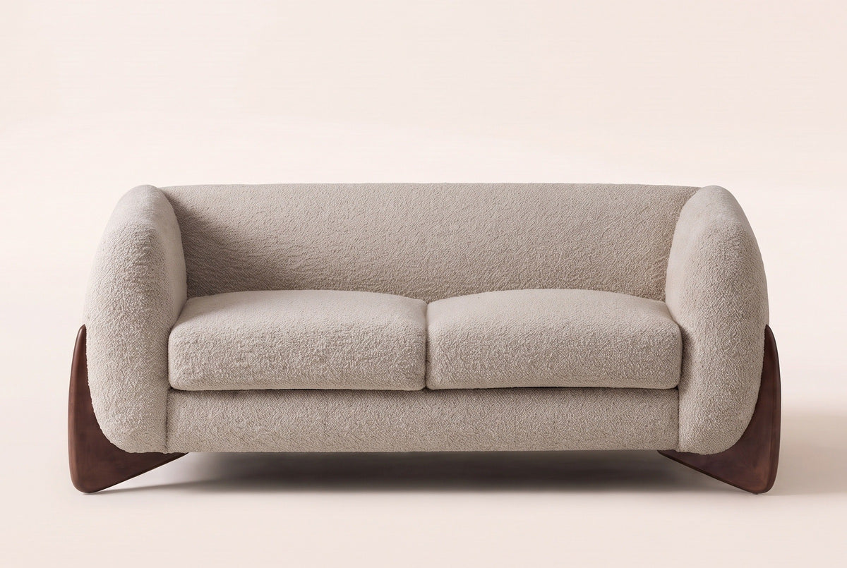 Greccio boucle loveseat in almond, straight front view with two seat cushions and walnut-stained wedge legs