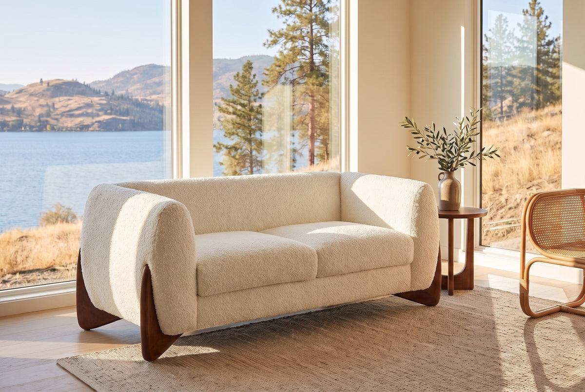 Greccio boucle loveseat in beige in a lake house living room with a lake and golden hills behind the windows