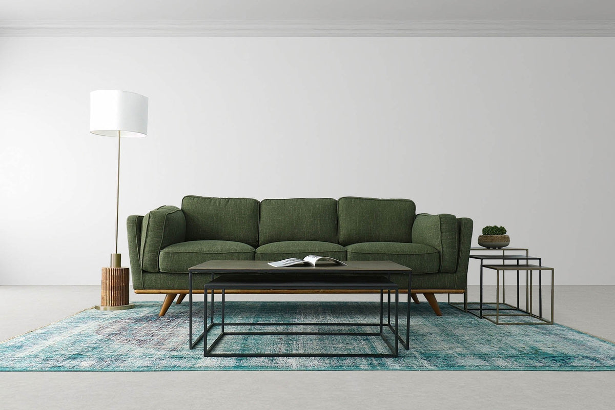 Hadrian floor lamp at the end of a green sofa in a living room