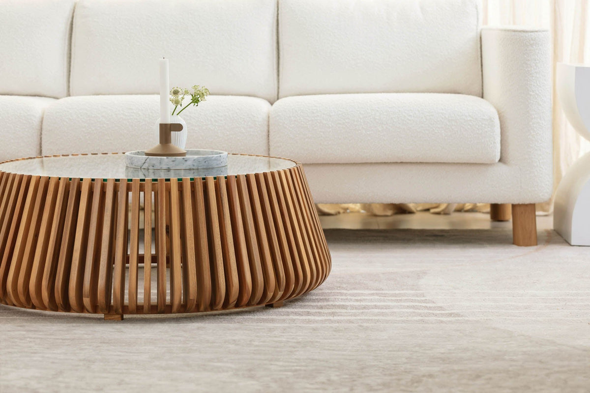Hartley round coffee table in front of a white boucle sofa