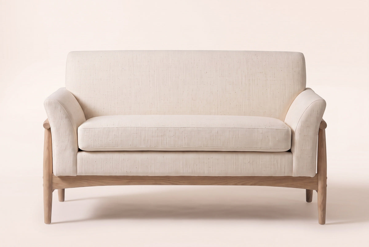 Jesi loveseat in beige woven fabric, straight front view: one long seat cushion, a tight back, flared arms and an arched natural-finish wooden apron