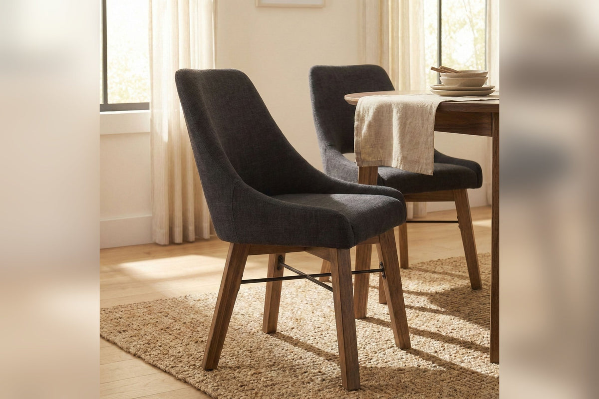 Two Keaton Graphite Grey dining chairs at a wood dining table on a jute rug