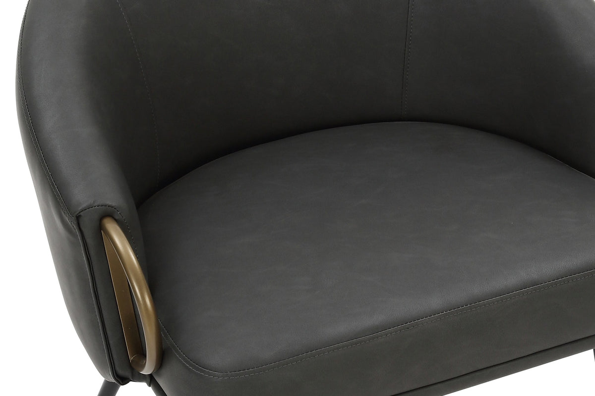 Close-up of the Kenna bucket seat, charcoal faux leather and aged gold arm ring