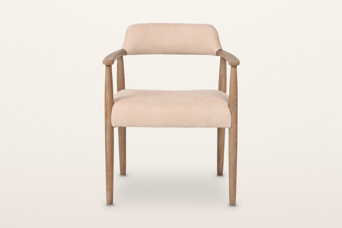 Laigueglia dining armchair in Beige leather, straight front view on a warm white studio backdrop: the back band