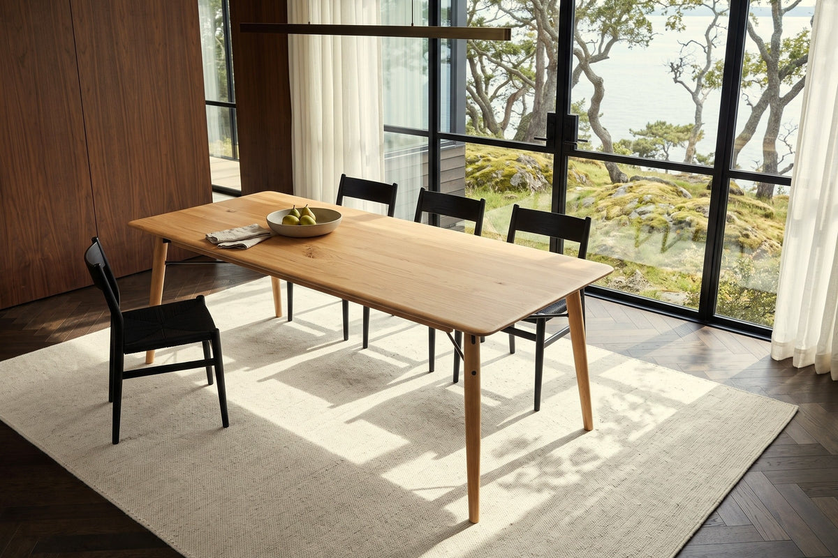 Larino dining table in Natural seen from above in a Victoria Uplands house, with walnut panelling, sheer curtains