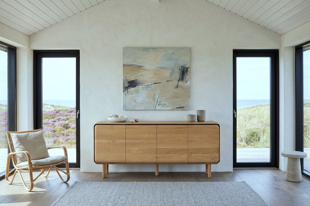 Larino sideboard in Natural and Black, front view, against lime plaster in a summer house on Fano