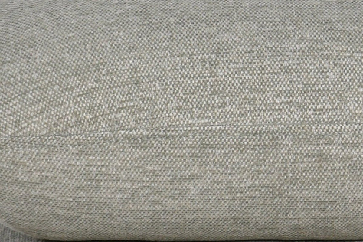 Close-up of the Lavagna ottoman in Sage: a pillow's rounded edge and its one fine seam over the pillow below
