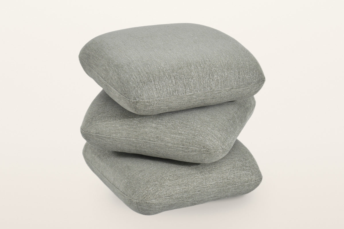 Lavagna ottoman in Sage with the top two pillows turned at an angle: they swivel