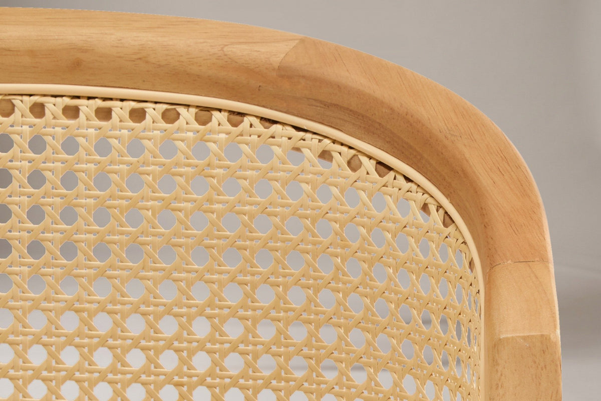 Close-up of the cane-look weave and the wood arch on the back of the Lazise counter stool