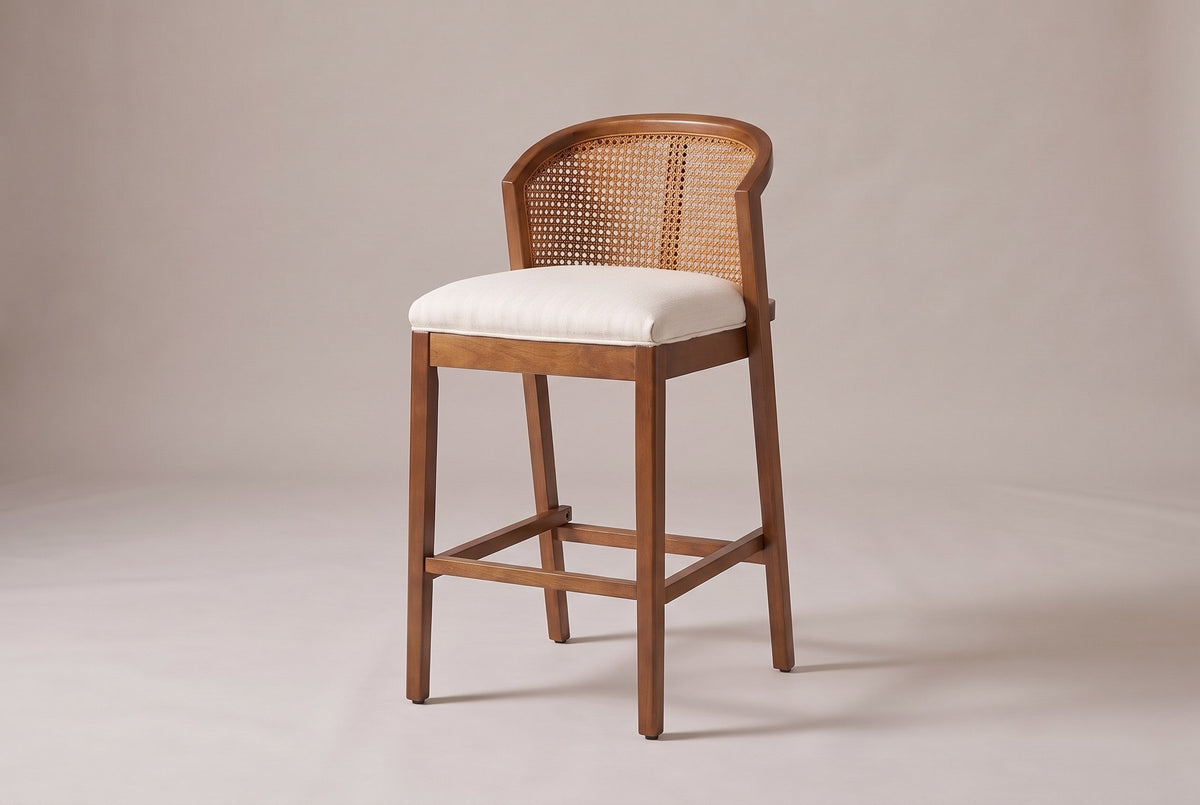 Lazise counter stool in a Walnut finish, three-quarter view on a warm grey studio backdrop