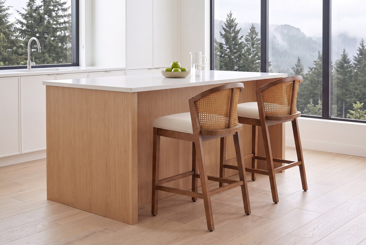 Two Lazise counter stools in the Walnut finish at a white-oak kitchen island in a bright Vancouver kitchen with cedar trees o