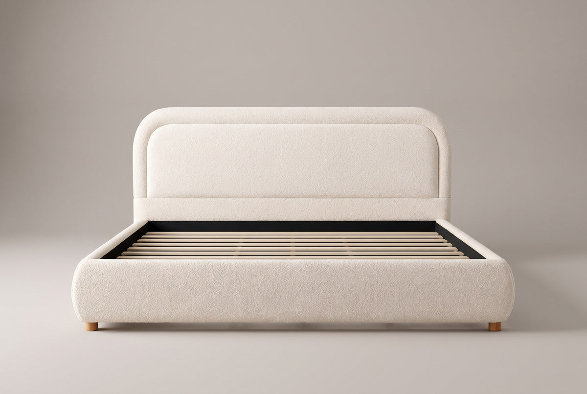 Lerici boucle bed in ivory, straight front view with the slats showing, on a studio backdrop