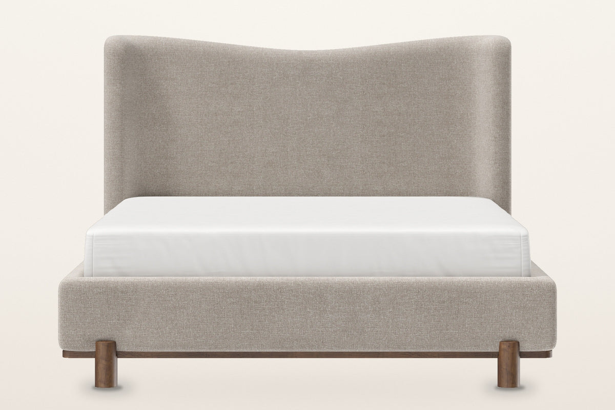 Lerma platform bed, straight front view: the tall headboard with its soft wave