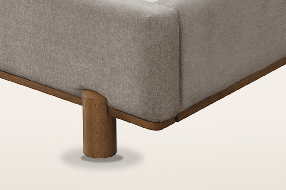 Corner of the Lerma bed: the padded rail on a thin walnut-finished wood base
