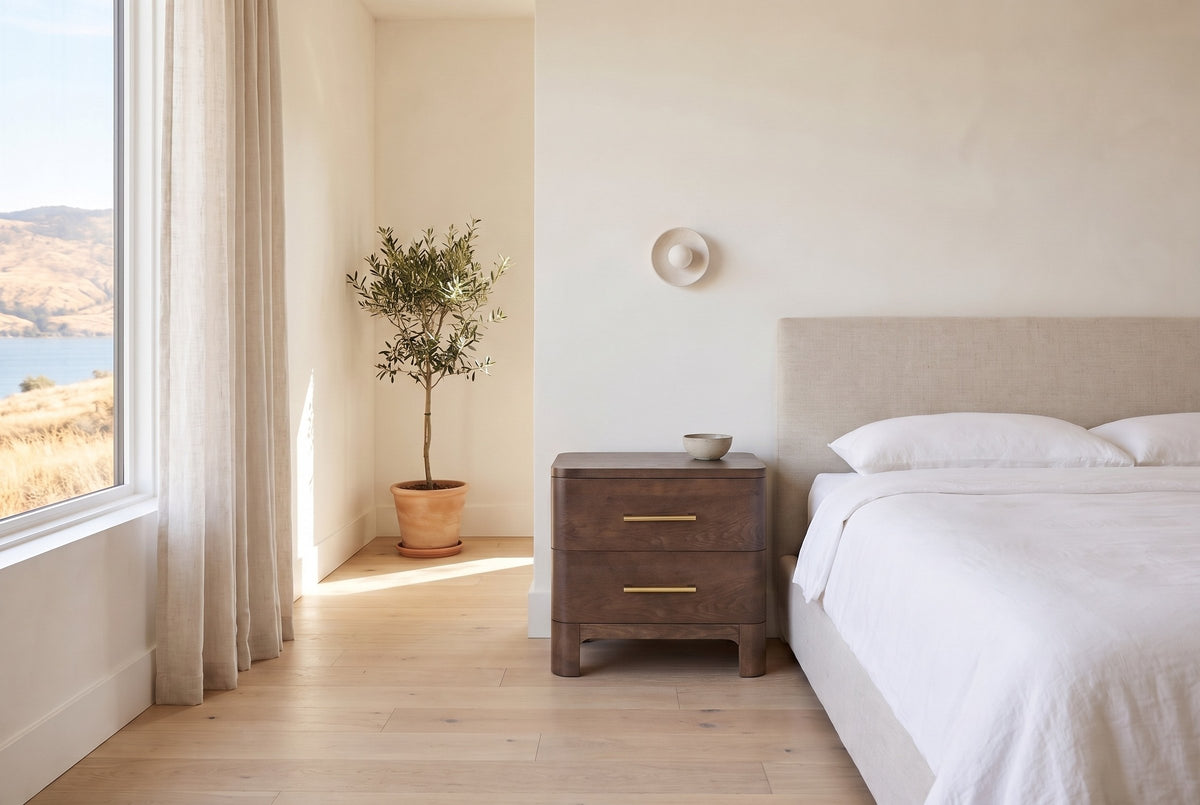 Lodi nightstand in Brown Oak beside a bed with white linen in a bright Kelowna lake-house bedroom