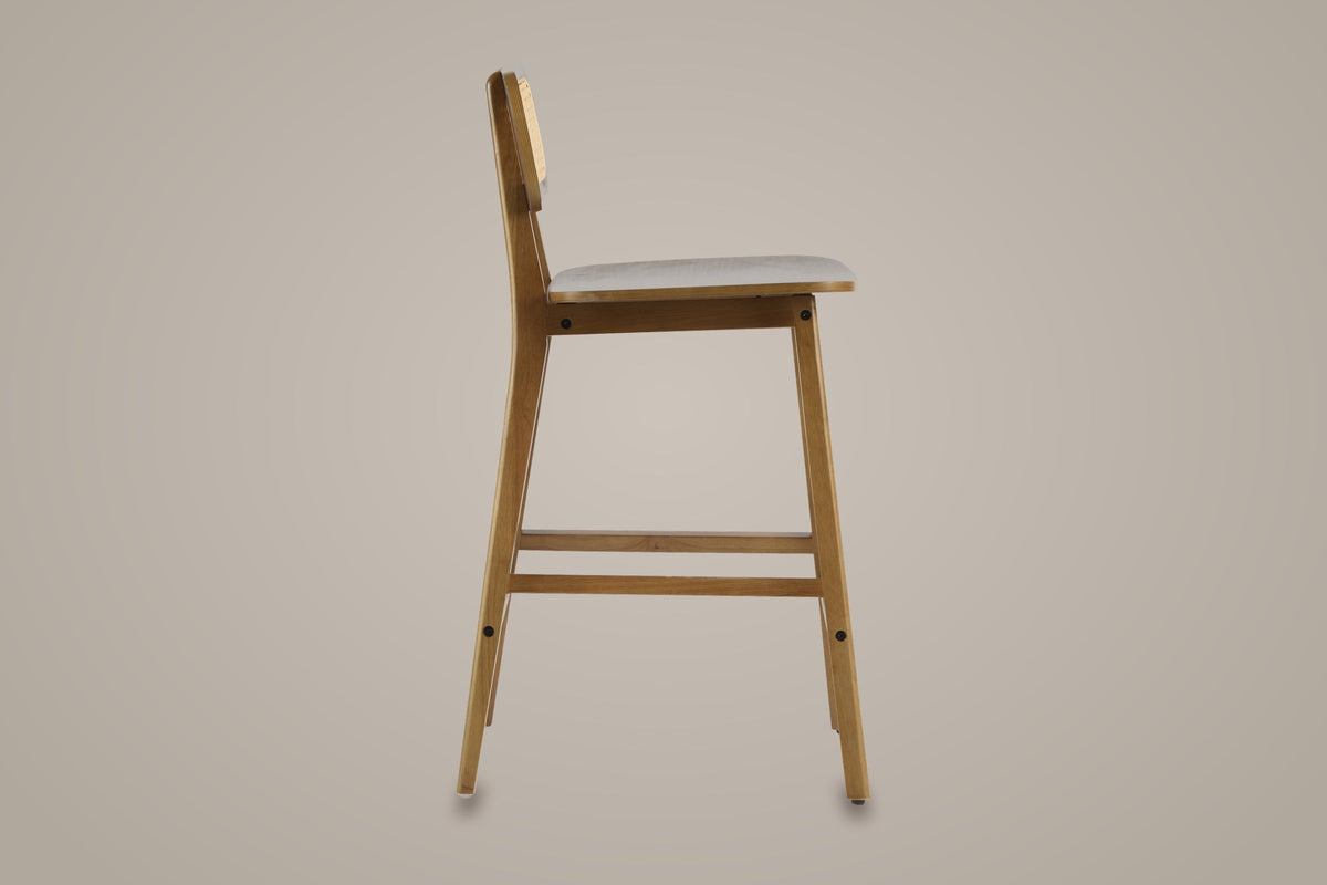 Lovere counter stool in Walnut, side view showing the seat height and the footrest