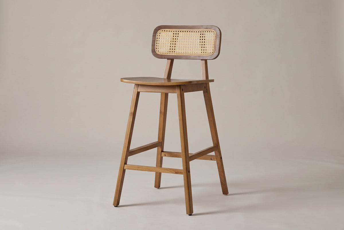 Lovere counter stool in Walnut, three-quarter view: cane-look back panel, walnut-veneer saddle seat