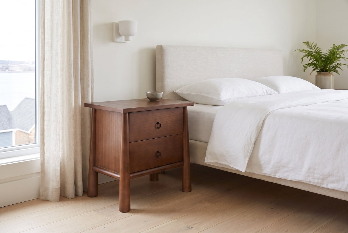 Malcesine nightstand beside a bed with white linen in a bright Halifax bedroom
