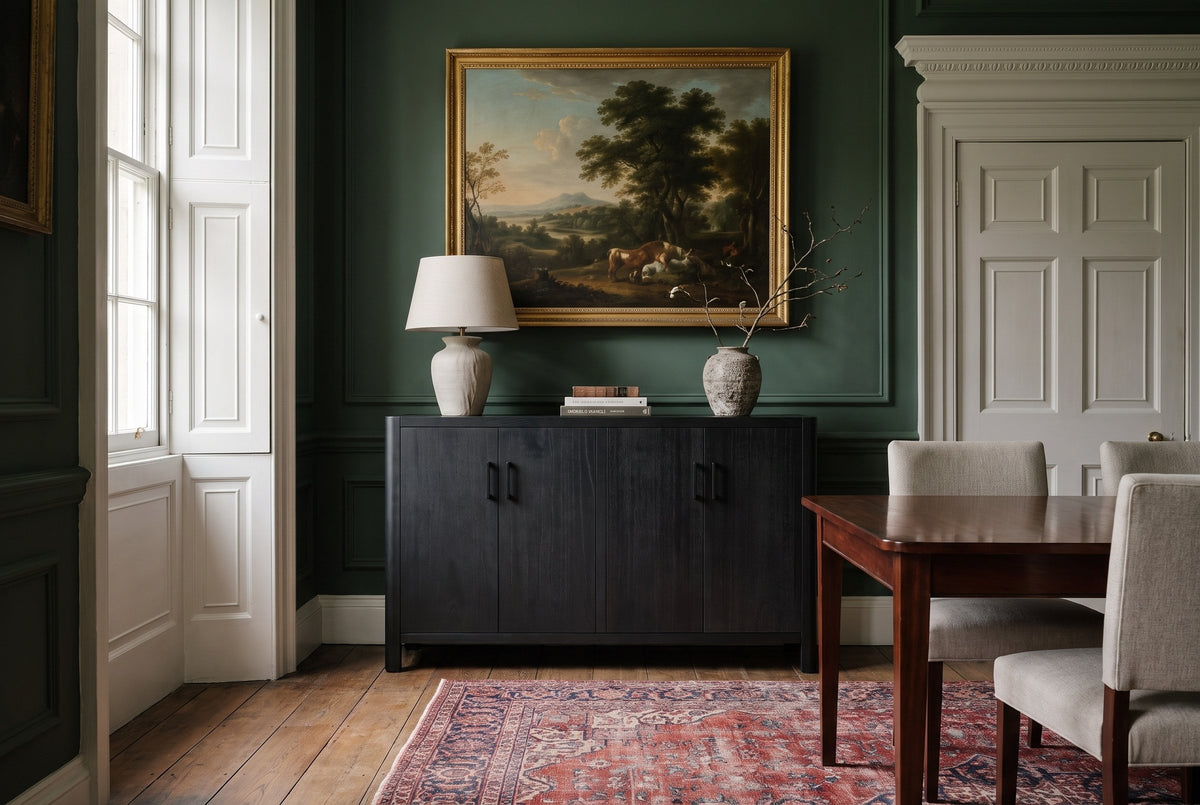 The Maren cabinet in Black below a gilt-framed landscape, in a deep green Georgian dining room in Bath with a Persian rug