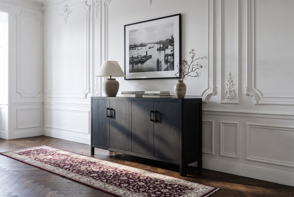 The Maren cabinet in Black below a black and white harbour photograph, in a Hamburg Jugendstil hallway with a herringbone floor