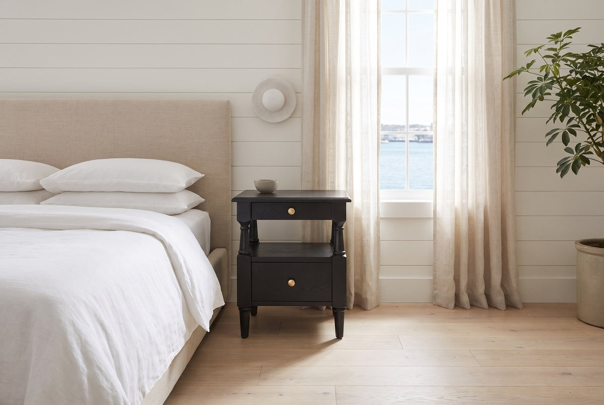 Marsala nightstand in Black beside a bed with white linen in a white shiplap Halifax bedroom with a harbour view
