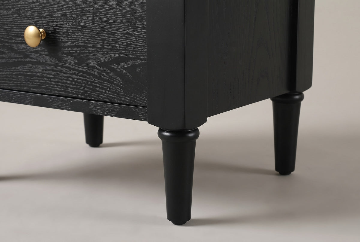 Close-up of a Marsala front leg: the chamfered corner stile and the turned, tapered leg