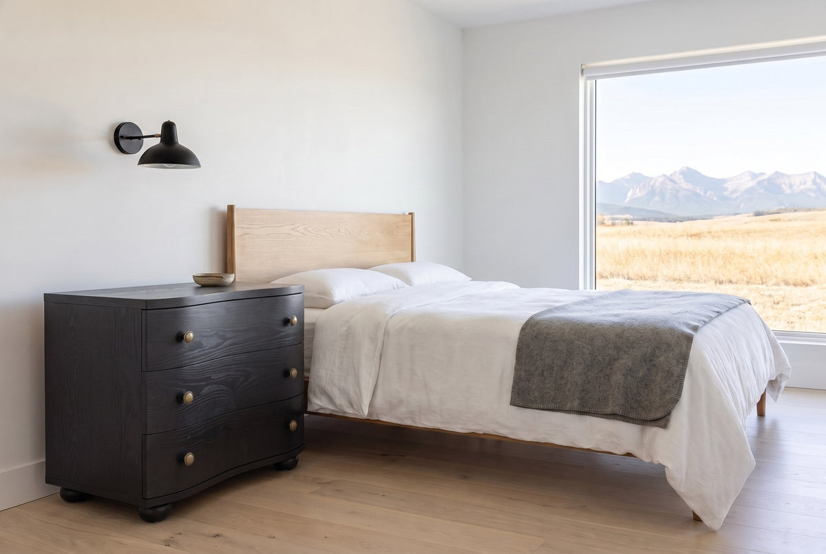 Merano nightstand in Black beside a bed in a white Calgary foothills bedroom with a view of the Rockies