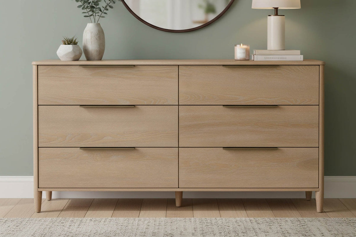 Merritt Sand oak dresser below a round mirror in a sage green bedroom